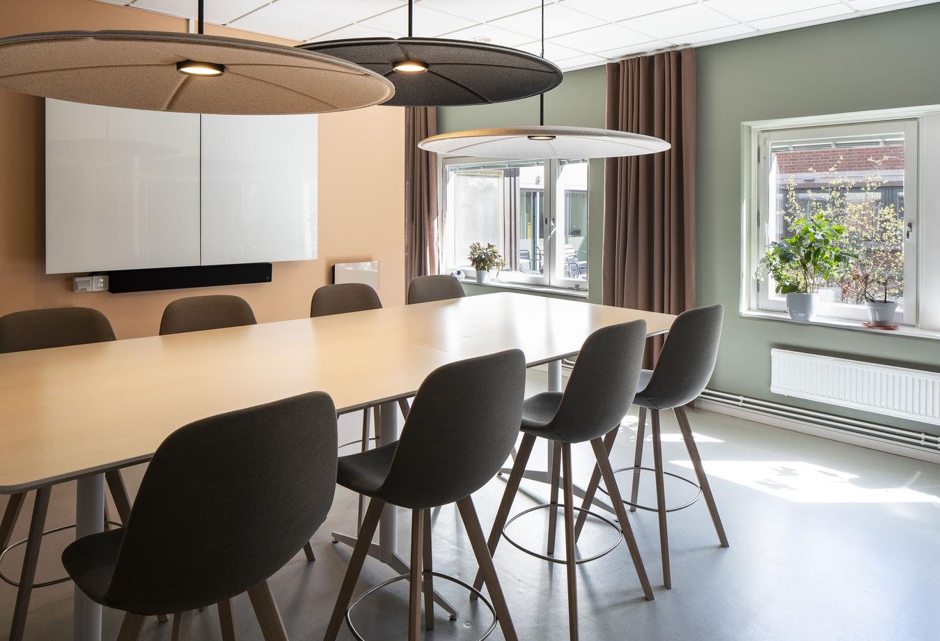 Interior in natural colors with long table and bar stools. Photo