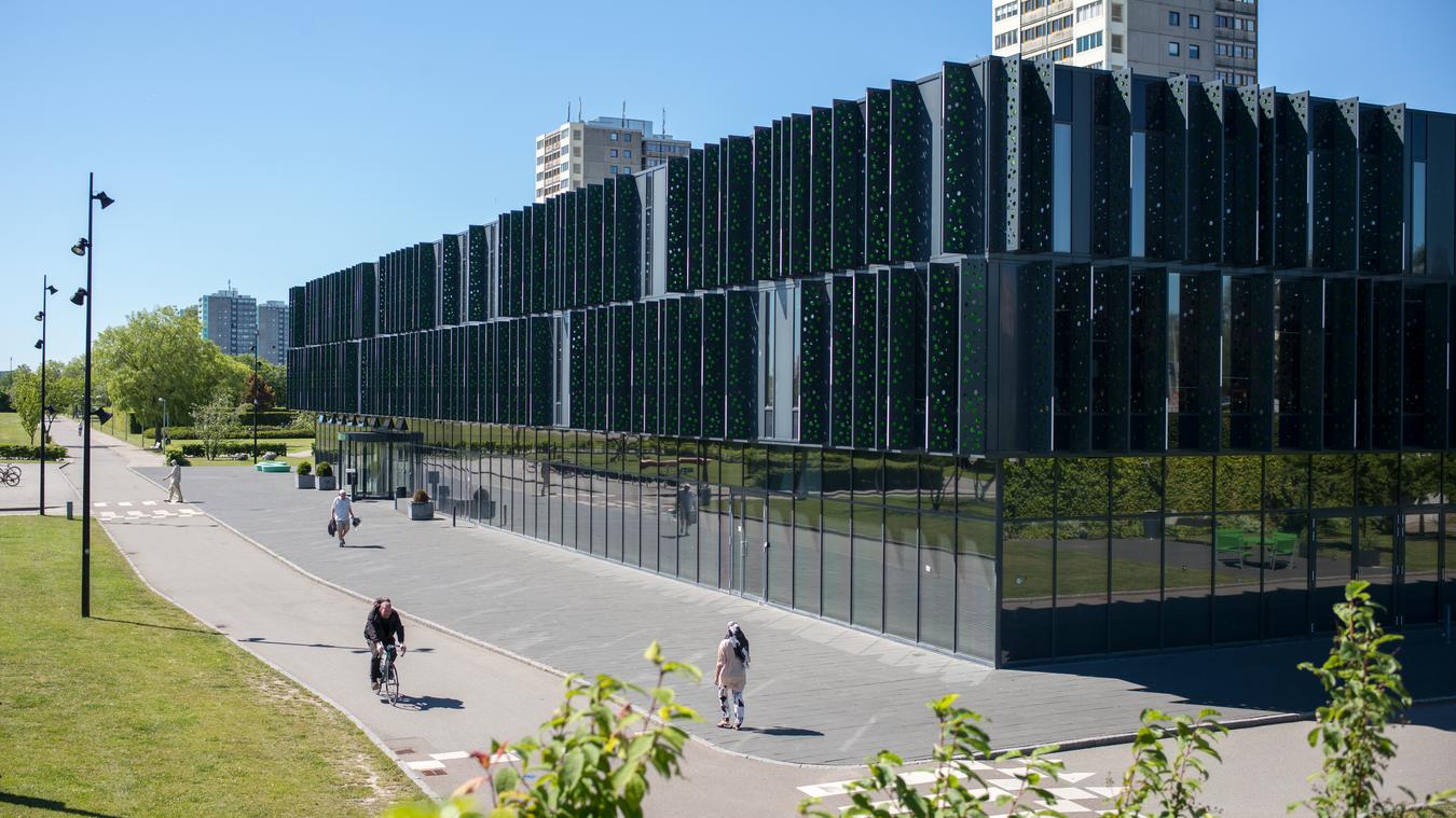 Fasad med breda trottoarer och cykelväg. Foto