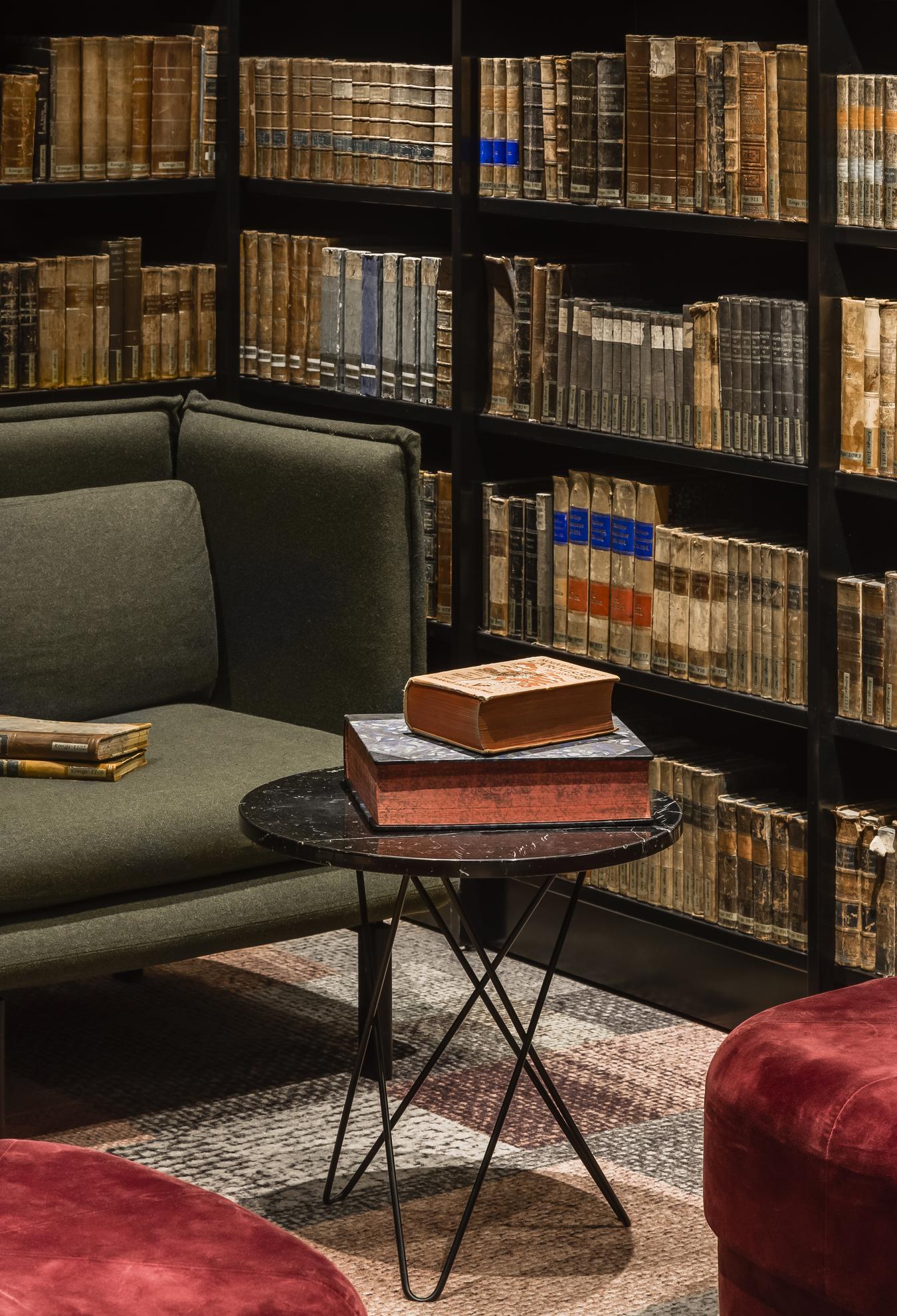 Coffee table and bookshelves with old books. Photo